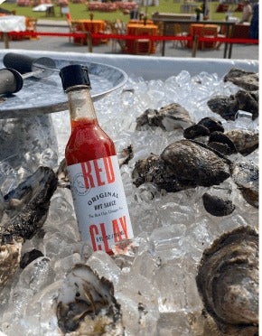Red Clay Original Hot Sauce on ice with fresh oysters